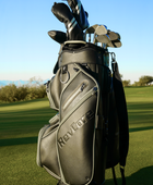 black golf cart bag and clubs on golf course